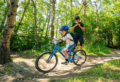 Kid learning how to bike during a private lesson on a closed trail at winsport