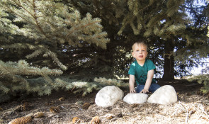 Boy playing with rocks at winsport 