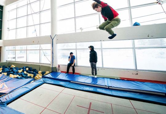 Athlete training on trampoline inside the Frank King Day Lodge