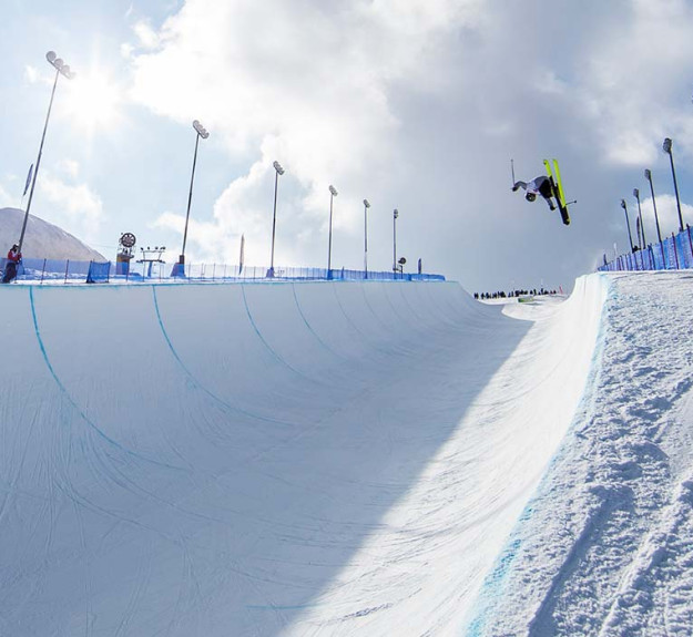 Skiier catching air on WinSports world cup half pipe