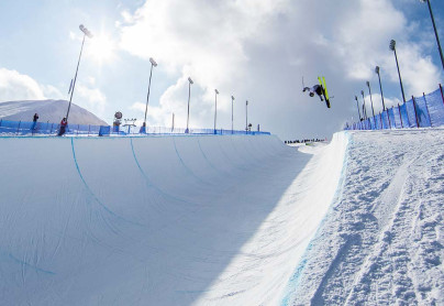 Skiier catching air on WinSports world cup half pipe