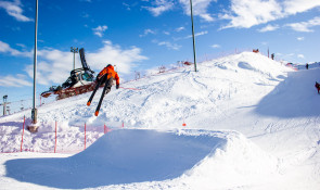 Skier going off a jump at the WinSport terrain park