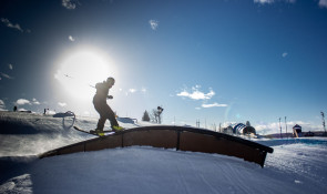 Skier hitting a rail at the WinSport Terrain Park