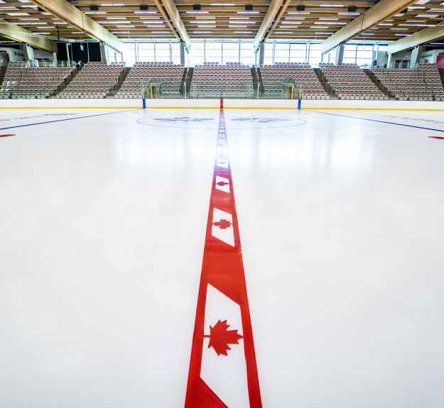 Winsport Arena centre ice redline with maple leafs 