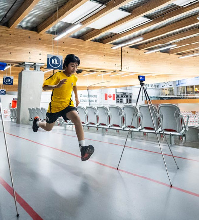 Off season hockey player running around WinSport Event Centre track