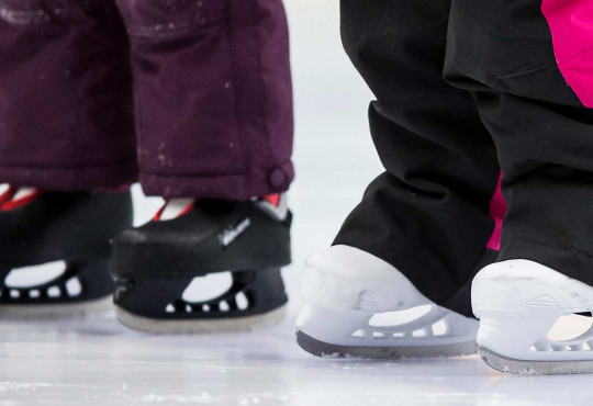 Close up of preschool skates on ice
