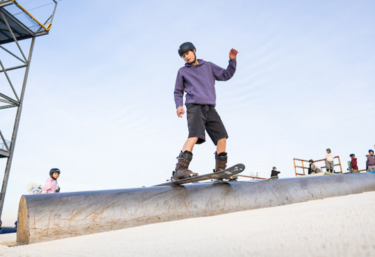 Freestyle skier practicing rail skills at the WinSport DrySlope