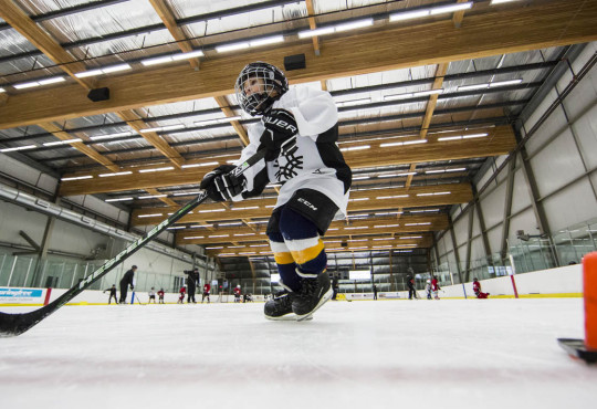 Winsport DevelopmentHockeyU11 boyskateswithpuckbetweenpylons