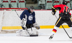 Hockey player on a breakaway against a goalie in WinSport Event Centre