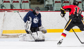 Hockey player on a breakaway against a goalie in WinSport Event Centre