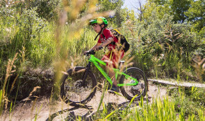 Child participating in Mini Enduro camp at WinSport on his mountain bike