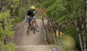 Mountain Biker getting air off a dirt jump followed by another rider v2