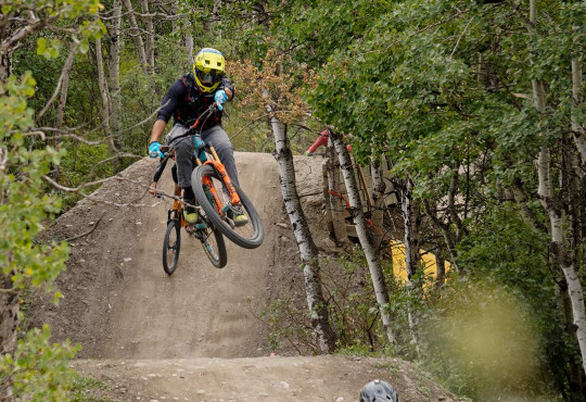 Mountain Biker getting air off a dirt jump followed by another rider v2