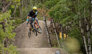 Mountain Biker getting air off a dirt jump followed by another rider v2