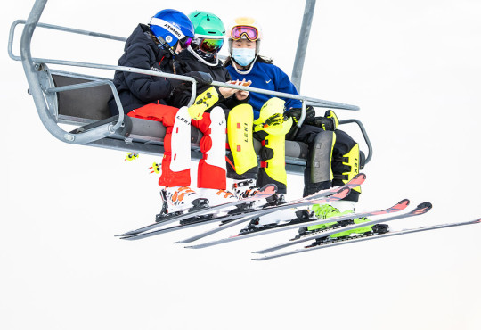 Group of teens on ski chairlift at winsport