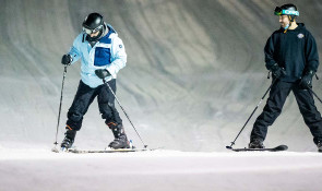 Two adults skiing on snow at WinSport