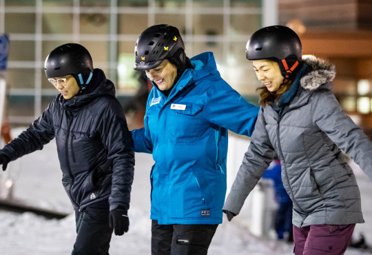 Winsport Womenslesson instructor with two snowboarders