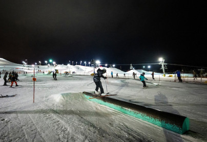 Young skiier on a rail at WinSport on a beautiful winter night