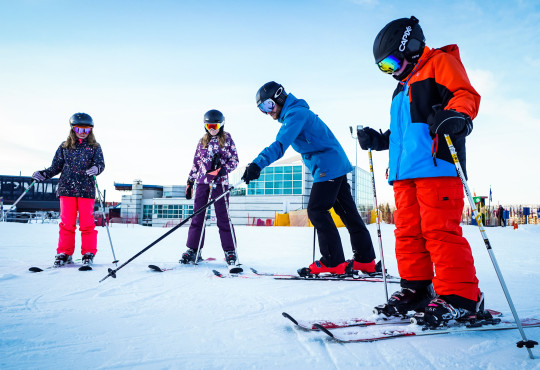 Winsport Ski lesson group of youth with instructor