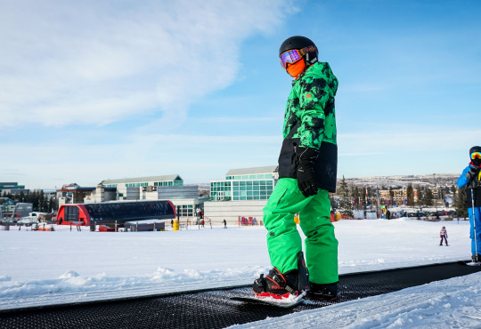 Boy on snowboard on the hill