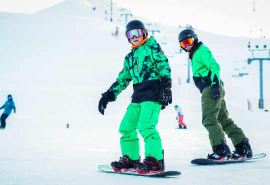 Winsport Snowboard lesson young people riding snowboards