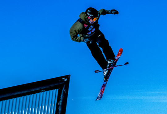 skiier exiting a rail at the alpine hill at winsport