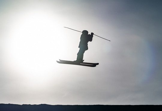 young girl doing a 360 off a slopestyle jump at winsport