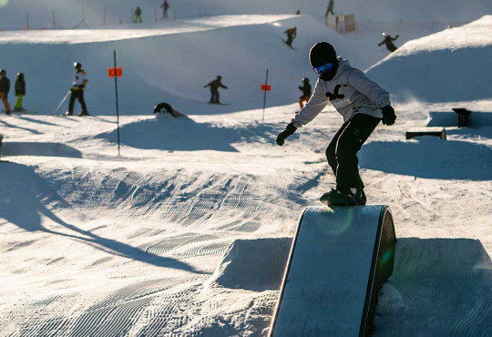 young kid learning how to properly boardslide on a box