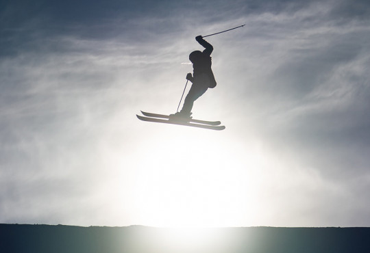 young skiier getting air off a slopestyle jump at winsport