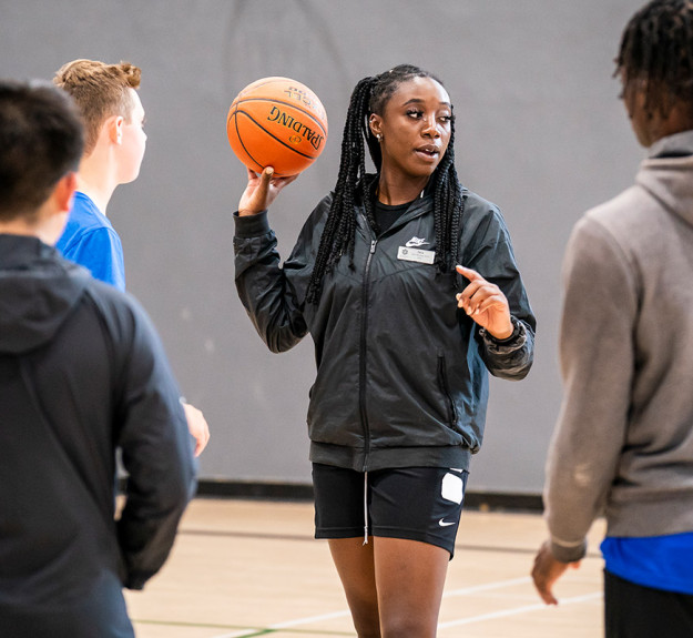 WinSport instructor teaching a class how to do the basketball v2
