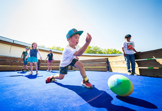 Children playing gaga ball on a court at WinSport