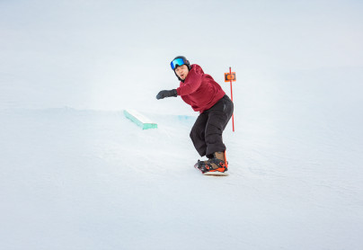 Snowboard excited about landing a trick on the progression park at WinSport Canada Olympic Park