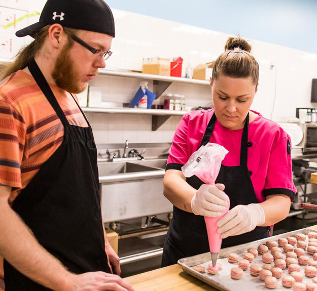 WinSport temporary job in the kitchen learning how to pipe desserts